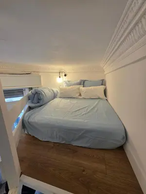 a bed in a small room with a window at Cozy studio, balcony & AC, Heart of Nice in Nice