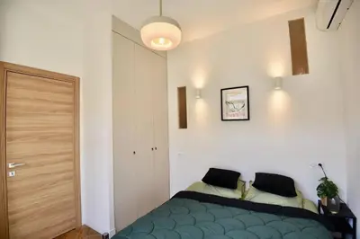 a bedroom with a blue bed in a room at Nice Signature The Port in Nice