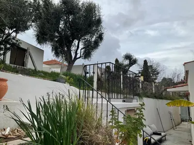 a staircase leading to a house with a tree at Maison avec vue mer et jacuzzi à 15 mn du centre in Nice