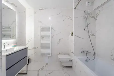 a bathroom with a toilet and a shower and a sink at Appartement Colombier - Welkeys in Saint-Laurent-du-Var