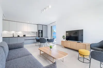 a living room with a couch and a table at Appartement Colombier - Welkeys in Saint-Laurent-du-Var
