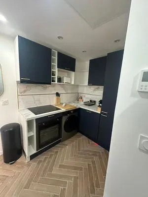 a kitchen with blue cabinets and a counter top at MASSENA 42 in Nice
