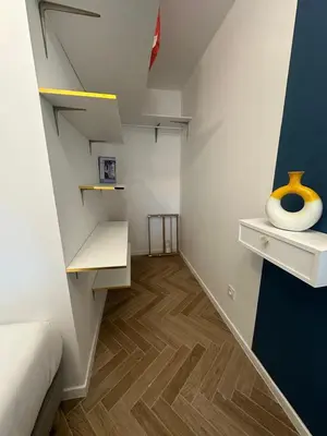 a room with a bed and a vase on a shelf at MASSENA 42 in Nice