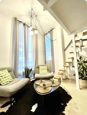 a living room with a couch and a table at Beautiful Carré d'Or studio in Nice