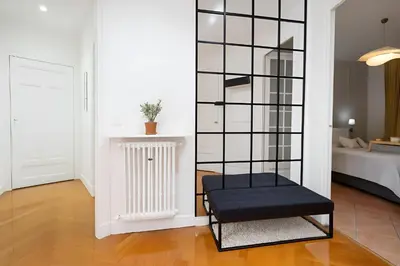 a black chair in a room with a bedroom at Azur elegance AIR CONDITIONING Beach 8 min Sleeps 6 in Nice