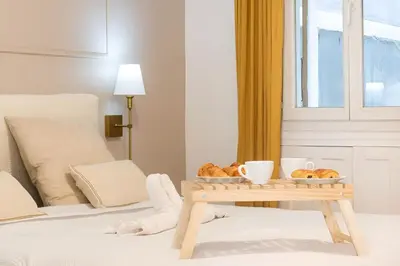 a table with a tray of pastries on a bed at Azur elegance AIR CONDITIONING Beach 8 min Sleeps 6 in Nice