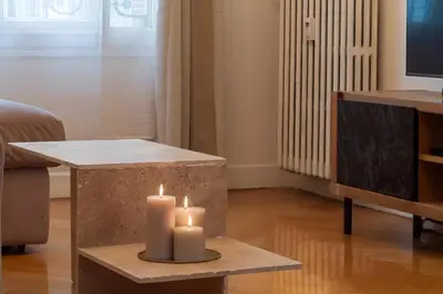 a living room with two candles on a table at Azur elegance AIR CONDITIONING Beach 8 min Sleeps 6 in Nice