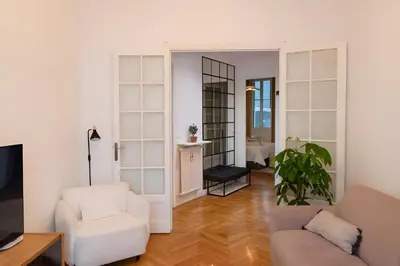 a living room with white furniture and a mirror at Azur elegance AIR CONDITIONING Beach 8 min Sleeps 6 in Nice