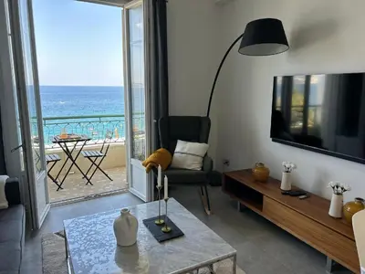 a living room with a view of the ocean at Appartement Prestige sur la Promenade des Anglais in Nice
