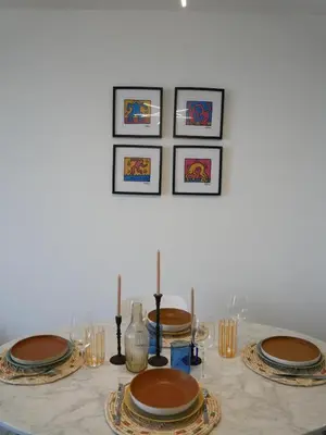 a table with plates and candles on top of it at Appartement Prestige sur la Promenade des Anglais in Nice