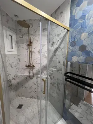 a shower with a glass door in a bathroom at Appartement Prestige sur la Promenade des Anglais in Nice