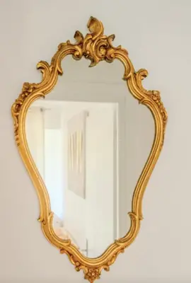 an ornate gold mirror on a white wall at Charming 80m for 6 people with garden in Cagnes-sur-Mer