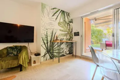 a living room with a large painting on the wall at Charming 80m for 6 people with garden in Cagnes-sur-Mer
