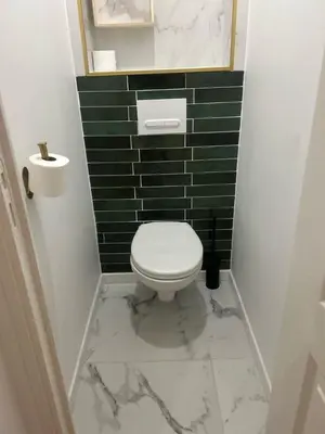 a bathroom with a white toilet and green tiles at MOON 26 - Appartement Nice 6P in Nice