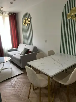 a living room with a table and a couch at MOON 26 - Appartement Nice 6P in Nice