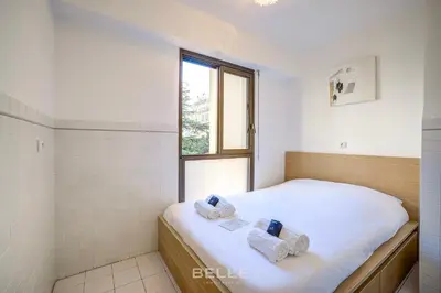 a bedroom with a bed with towels on it at Résidence Grand Hôtel Nice in Nice
