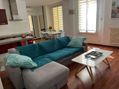 a living room with a couch and a table at cosy appartement in Nice