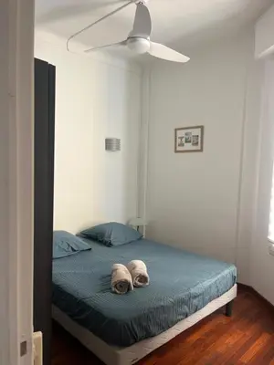 a bedroom with a bed with two hats on it at cosy appartement in Nice
