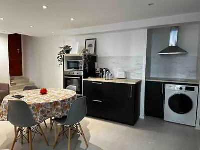 a kitchen with a table with chairs and a dining room at Palais Clerissy - Appartement 2 à 4 personnes centre ville Nice in Nice