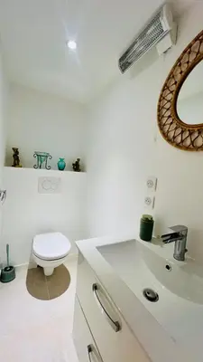 a white bathroom with a toilet and a sink at Palais Clerissy - Appartement 2 à 4 personnes centre ville Nice in Nice
