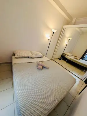 a room with a bed with a teddy bear on it at 2 Pièces en étage au Centre-ville de Nice in Nice