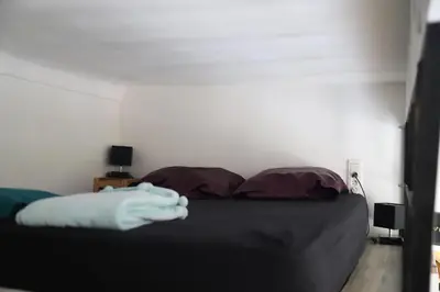 a bedroom with a black bed with two pillows at Cozy apartment in Nice Est in Nice