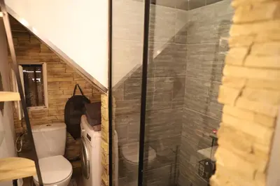 a bathroom with a toilet and a glass shower at Cozy apartment in Nice Est in Nice