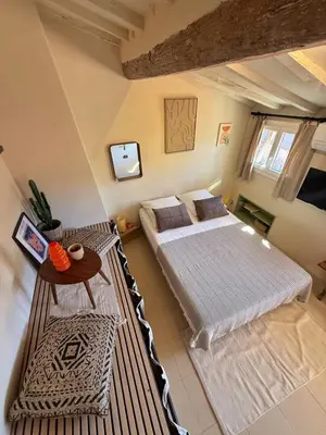 a large bedroom with two beds and a table at Studio Place Rossetti - Old Nice Center in Nice