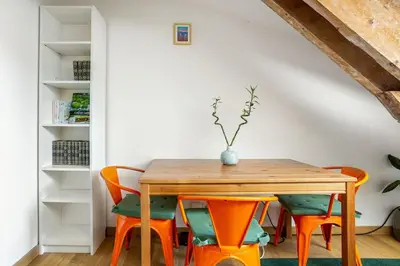 a dining room with a wooden table and chairs at Cosy 2 pieces au Coeur du Centre Ville in Nice
