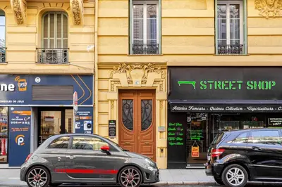 two cars parked on a street in front of a building at Cosy 2 pieces au Coeur du Centre Ville in Nice