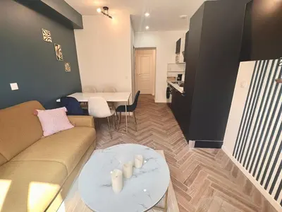 a living room with a couch and a table at MASSENA 27 in Nice