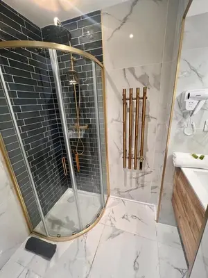 a shower with a glass door in a bathroom at MASSENA 27 in Nice