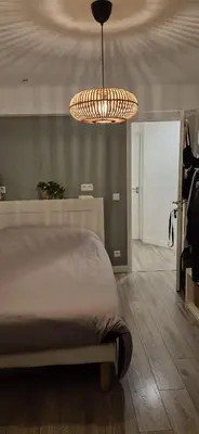 a bedroom with a bed and a chandelier at chambre privé chez l'habitant avec salle de bain privative in Nice
