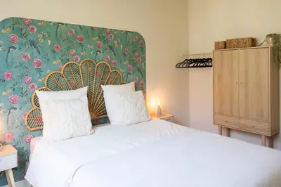 a bedroom with a white bed with a floral headboard at L9 Marechal 2BDR Marechal, 5 min Sea10 min Old Town Parking AC in Nice