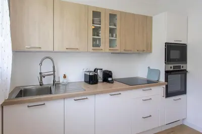 a kitchen with white cabinets and a sink at L9 Marechal 2BDR Marechal, 5 min Sea10 min Old Town Parking AC in Nice