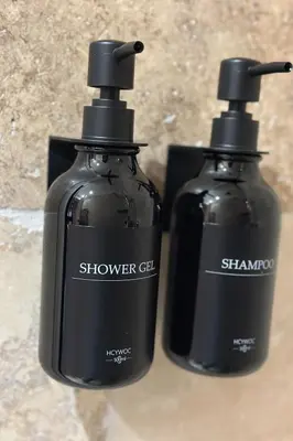 two black bottles of soap sitting next to each other at Le Notre Dame in Nice