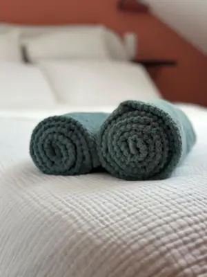 a rolled up towel on top of a bed at Le Notre Dame in Nice