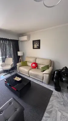a living room with a couch and a table at Modern apartment with sunny terrace in Nice