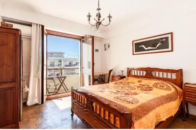 a bedroom with a bed and a large window at Absea Nice Port 2 in Nice