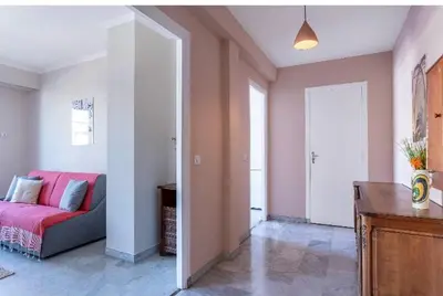 a living room with a pink couch in a room at Absea Nice Port 2 in Nice