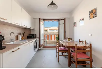 a kitchen with a table and chairs and a window at Absea Nice Port 2 in Nice