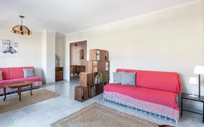 a living room with a red couch and a book shelf at Absea Nice Port 2 in Nice