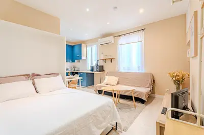 a bedroom with a bed and a living room at Fontaine de la Ville in Nice