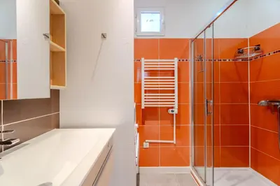 a bathroom with a shower and a sink and a tub at Fontaine de la Ville in Nice