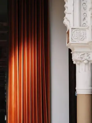 a red curtain and a white column in front of a curtain at Appartement Haut Standing coeur de Nice pour 6pers in Nice