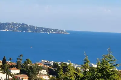 a view of a city and the ocean with houses at CASA-Martine vue sur mer et parking privé in Nice