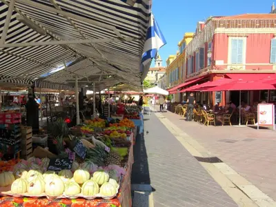 a market with fruits and vegetables on a street at Appartements Massena in Nice