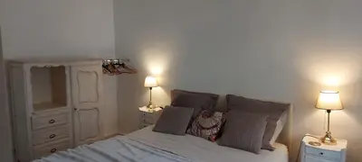a bedroom with a bed with two lamps on tables at Appartements Massena in Nice