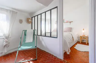 a bedroom with a bed and a window and a mirror at Le Collet - appt climatisé proche plage in Nice