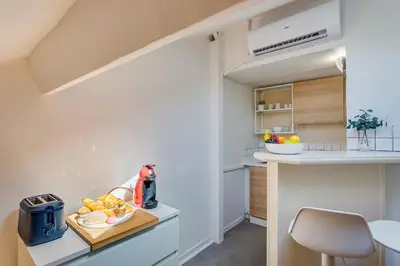 a kitchen with a counter with a bowl of fruit on a cutting board at ATTIC URBAN AP4485 by Riviera Holiday Homes in Nice